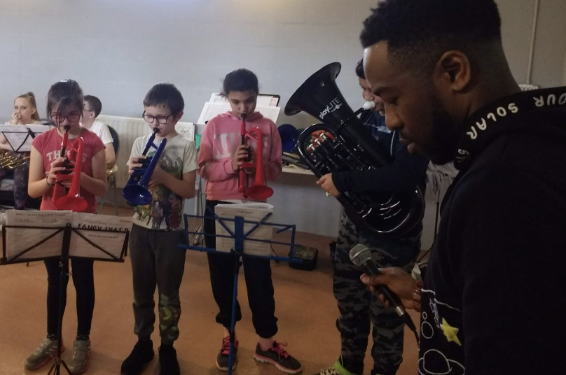 A group of young musicians playing their cornets.