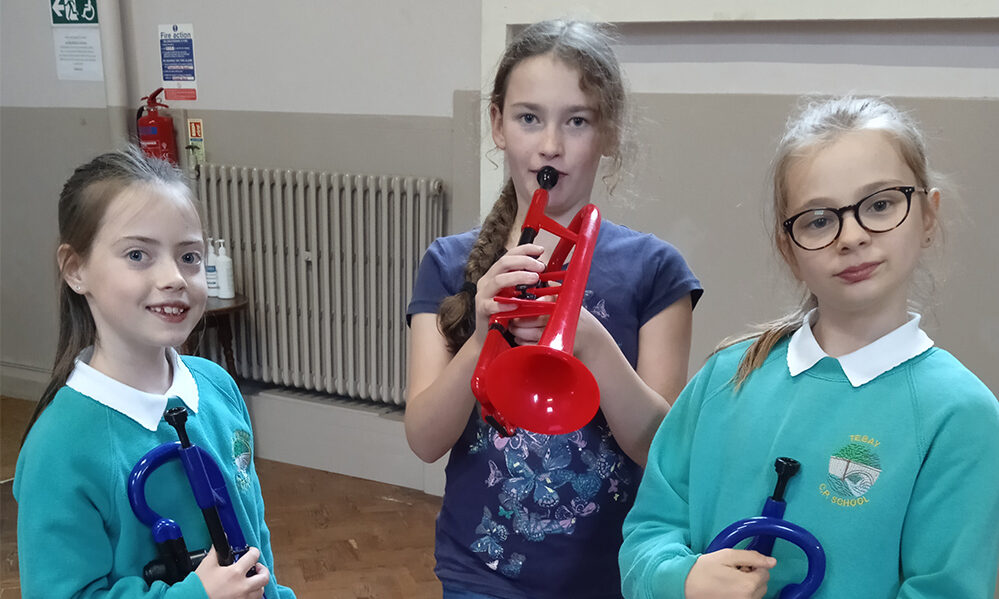 3 girls and plastic brass instruments